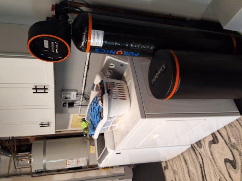 Conducted on-site inspection and estimate for tankless water heater conversion. Evaluated existing water heating system including current tank-style water heater, associated copper piping, and HVAC equipment configuration in mechanical room. Discussed permit requirements for conversion project and available payment options with property owner. Documented existing installation with photographs for estimate preparation.