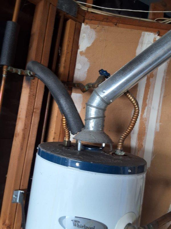 Responded to service call for leaking 30-gallon gas water heater (Model: MFG153030T3NOV, Serial: 0649108780) located in unfinished basement utility area. Conducted thorough inspection of existing Whirlpool unit, photographed installation including water and gas line connections, venting configuration, and surrounding workspace conditions. Assessed leak source and determined unit requires replacement due to age and condition. Provided estimate for installation of 40-gallon gas water heater replacement contingent on dimensional verification for available space. Discussed permit requirements with customer, who requested permit be obtained for installation work. Reviewed available payment options and provided ballpark estimate range for complete replacement including new unit, installation labor, venting modifications if needed, and permit fees.