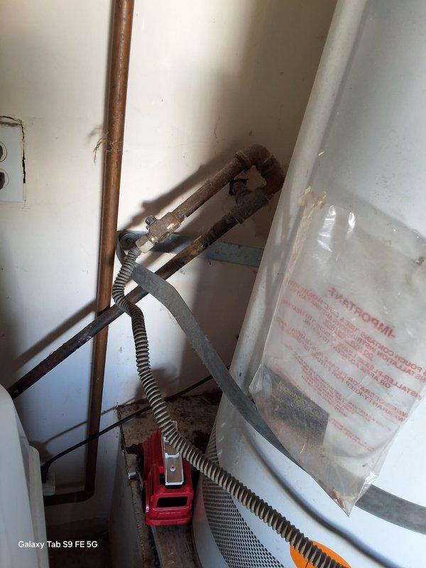 Responded to service call for leaking 40-gallon gas water heater. Upon inspection, confirmed active leak from existing unit with no available age or model information. Removed and properly disposed of failed water heater. Installed new 40-gallon gas water heater with appropriate gas connections using flexible copper gas lines and control valve assembly. Secured unit with metal safety strapping per code requirements. Connected water supply lines, installed temperature and pressure relief valve with discharge piping, and verified proper venting configuration. Tested all gas connections for leaks, confirmed proper ignition and burner operation, and verified adequate hot water delivery. Discussed permit requirements with property owner and provided information regarding available payment options.
