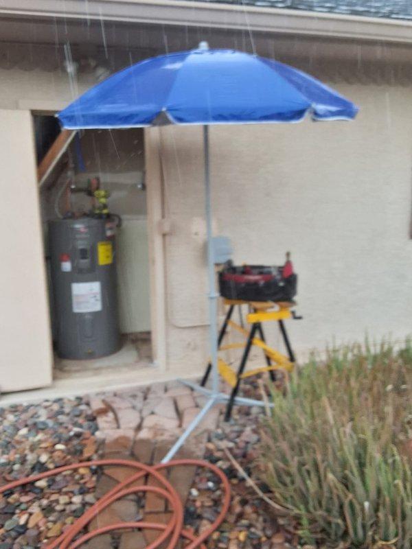 Responded to service call for ignition system failure on a Rheem 50-gallon electric water heater (Model XE50M12TS55UI, Serial Q012037833) originally installed in 2020. Upon arrival, performed diagnostic testing using multimeter to verify electrical supply and component functionality, confirming 240V power delivery to unit. After thorough assessment of the ignition system malfunction and evaluation of repair versus replacement options, provided customer with comprehensive replacement recommendations and pricing estimates for new water heater installation. Set up outdoor workspace with weather protection to facilitate equipment testing and customer consultation. Documented existing unit specifications and electrical readings for replacement planning purposes.