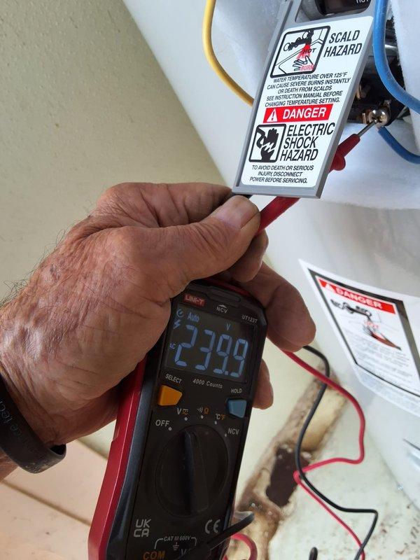 Responded to service call for ignition system failure on a Rheem 50-gallon electric water heater (Model XE50M12TS55UI, Serial Q012037833) originally installed in 2020. Upon arrival, performed diagnostic testing using multimeter to verify electrical supply and component functionality, confirming 240V power delivery to unit. After thorough assessment of the ignition system malfunction and evaluation of repair versus replacement options, provided customer with comprehensive replacement recommendations and pricing estimates for new water heater installation. Set up outdoor workspace with weather protection to facilitate equipment testing and customer consultation. Documented existing unit specifications and electrical readings for replacement planning purposes.