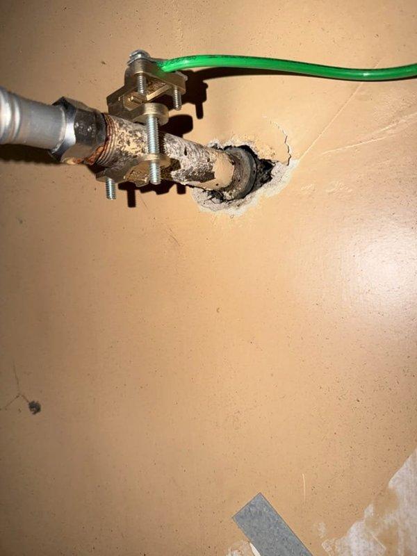 Performed inspection of aging gas water heater showing signs of wear and discoloration. Unit age and serial number unavailable due to label deterioration. Evaluated existing installation including gas line connections, plumbing fittings, and grounding wire configuration. Observed yellow flexible gas line, brass valve assembly, and metallic flexible connectors at top of unit. Discussed replacement options with customer for 40 or 50-gallon gas water heater. Provided ballpark estimate range for complete replacement installation. Reviewed permit requirements for water heater replacement work. Documented existing conditions through photographs showing current unit placement in utility closet, visible wear patterns, and connection points. Advised customer of available payment methods and next steps for proceeding with replacement.