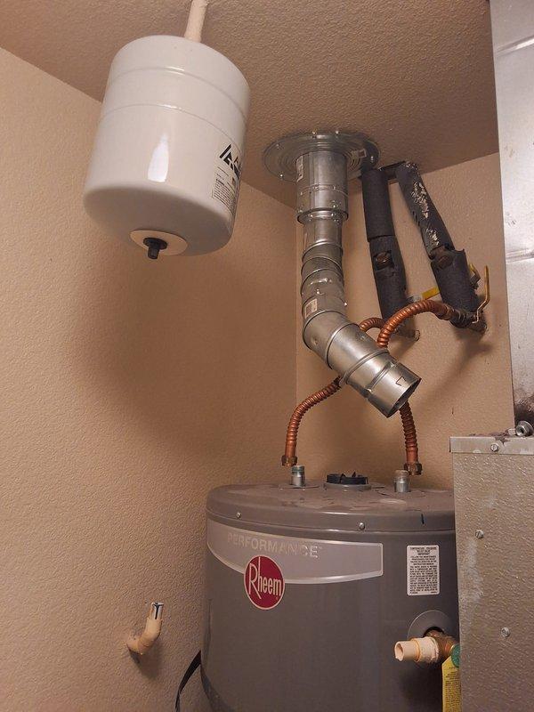 Removed and replaced leaking 50-gallon gas water heater with new Rheem Performance unit per property management request. Installation included new flexible copper water connectors, expansion tank, pressure relief valve, and all required code-compliant plumbing connections. Unit tested and verified operational upon completion.