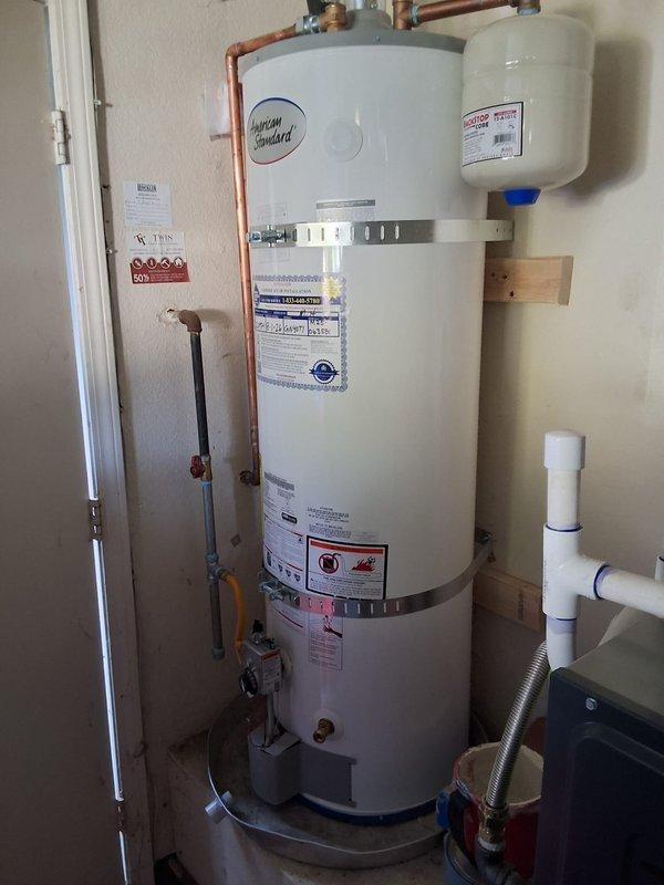 Responded to warranty call for American Standard water heater model GN40TI-3-6NAT experiencing cross-connection issue where cold water supply was delivering hot water. Inspected installation and plumbing connections, tested system pressure using calibration gauge, and verified proper operation of expansion tank and all associated valves. Corrected plumbing configuration to resolve cross-connection, restoring proper cold and hot water distribution throughout the system.