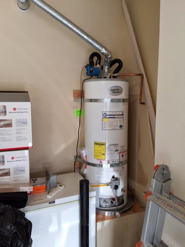 Responded to no hot water complaint on American Standard water heater model GN50T136, serial C25-012976. Upon inspection, unit was approximately one year old and still within labor warranty period. Performed diagnostic evaluation of water heater installed in utility space, checked all plumbing connections, gas line, venting system, and electrical components. Verified proper operation of unit, documented installation with photos showing copper piping connections, blue shut-off valve, metallic safety strap, and venting duct configuration. All manufacturer labels and EcoChoice specifications visible and intact on unit exterior.