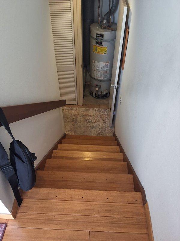 Responded to no hot water condition at residential property with 21-year-old 40-gallon gas water heater (Model M440T6FBN) located in interior closet accessed via basement stairwell. Performed complete water heater replacement, installing new 40-gallon gas unit with proper venting and connections to existing gas and water supply lines.