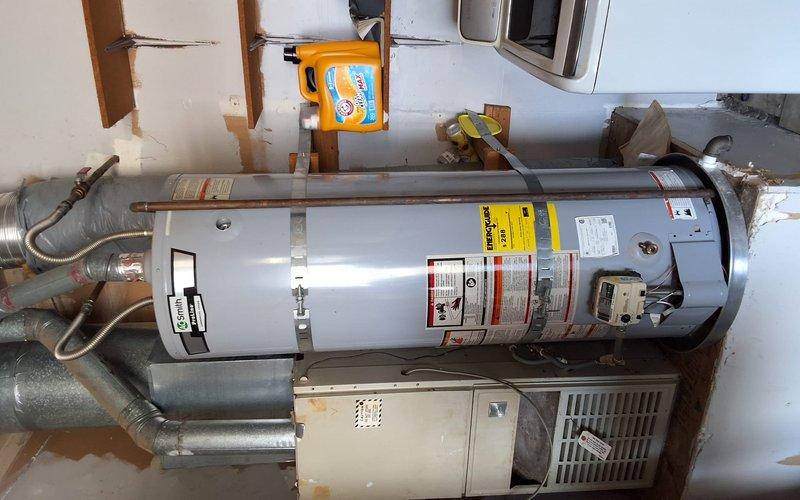 Responded to service call for 40-gallon gas-powered residential water heater requiring diagnostic and repair evaluation. Performed comprehensive inspection of unit including burner assembly, pilot light system, thermocouple, gas valve, and venting components. Assessed condensate drain line routing and verified proper installation clearances in confined utility space. Informed customer of upcoming regulatory mandates affecting gas appliance installations and provided options for repair versus replacement. Customer elected to proceed with repair attempt prior to considering full unit replacement. Completed necessary repairs to restore hot water functionality and verified all safety systems operating within manufacturer specifications.