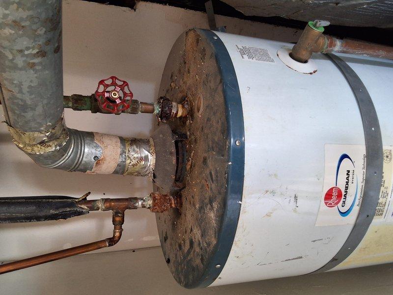Responded to service call for leaking 40-gallon gas water heater. Upon inspection, found extensive rust and corrosion on top plate, valve connections, and piping, indicating significant deterioration and active gas leak. Documented existing conditions with photographs showing compromised components and safety hazards. Provided estimate for complete water heater replacement with new 40-gallon gas unit, discussed permit requirements for installation, and reviewed available payment options with property owner.