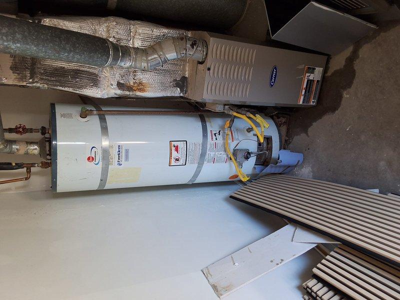 Responded to service call for leaking 40-gallon gas water heater. Upon inspection, found extensive rust and corrosion on top plate, valve connections, and piping, indicating significant deterioration and active gas leak. Documented existing conditions with photographs showing compromised components and safety hazards. Provided estimate for complete water heater replacement with new 40-gallon gas unit, discussed permit requirements for installation, and reviewed available payment options with property owner.