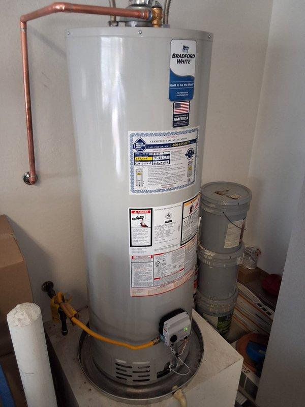 Responded to service call for leaking tank on a 2018 PROG5040N residential gas water heater. Successfully removed and replaced the failed unit with a new 40-gallon gas Bradford White water heater, including proper venting installation with metallic ductwork, copper supply line connections with brass fittings and temperature/pressure relief valve, and yellow flexible gas line hookup. Installation completed within promised arrival window with all connections tested and verified leak-free.