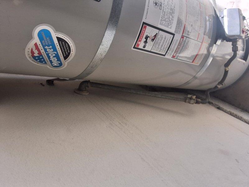 Responded to service call for pilot light issue on residential water heater. Upon arrival, inspected unit model UDS140S6FRN, serial number JC16392843. Diagnosed pilot light failure and provided customer with repair options including parts and labor estimate. Discussed complete water heater replacement as alternative solution and provided free estimate for new unit installation. Informed customer of permit requirements and associated fees for replacement work if needed. Documented equipment condition with photographs showing existing installation configuration and unit specifications. Customer to advise on preferred course of action for pilot light repair versus full replacement.