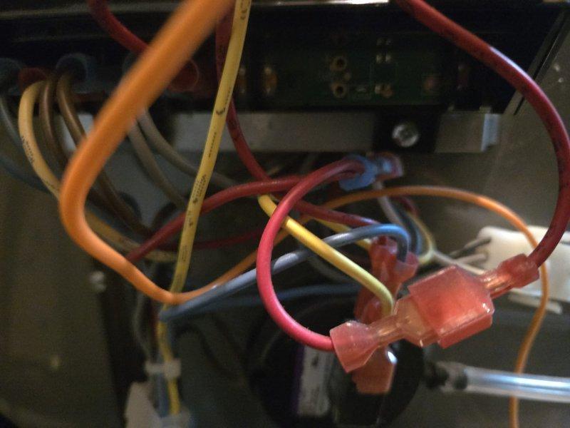 Responded to no hot water complaint at hotel facility. Diagnosed Rheem GNU100-200 water heater located in 3rd floor mechanical room. Performed electrical inspection of control board, wiring connections, and capacitor components. Documented existing wire connections and electrical components for repair assessment.