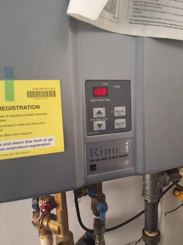 Responded to property management call for Rinnai RUC90I tankless water heater displaying error code 10. Upon arrival, performed diagnostic evaluation of the unit and documented current conditions with photographs showing the wall-mounted installation, control panel displaying temperature reading of 129°F, copper supply lines with shutoff valves, PVC venting configuration, and all associated plumbing connections. Completed onsite assessment and contacted office with findings per property management protocol for pricing approval before proceeding with any repairs.