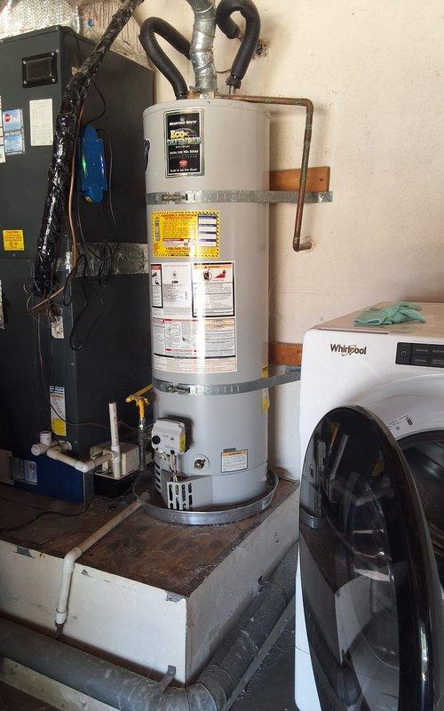 Replaced 11-year-old 40-gallon residential gas water heater (model U140T6GBN) in garage with new 40-gallon gas unit. Removed existing water heater from platform base, disconnected copper supply lines and gas connections, and installed replacement American Standard water heater with proper venting and code-compliant plumbing connections. Installed expansion tank, verified all gas connections for leaks, tested temperature and pressure relief valve operation, and ensured proper combustion air supply and draft hood installation.