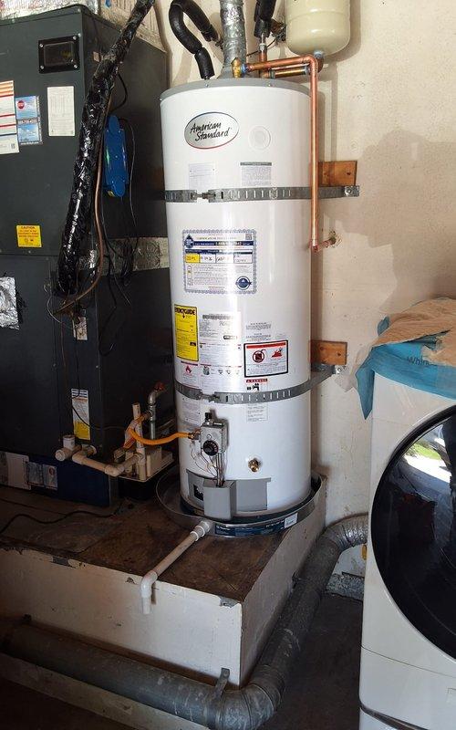 Replaced 11-year-old 40-gallon residential gas water heater (model U140T6GBN) in garage with new 40-gallon gas unit. Removed existing water heater from platform base, disconnected copper supply lines and gas connections, and installed replacement American Standard water heater with proper venting and code-compliant plumbing connections. Installed expansion tank, verified all gas connections for leaks, tested temperature and pressure relief valve operation, and ensured proper combustion air supply and draft hood installation.
