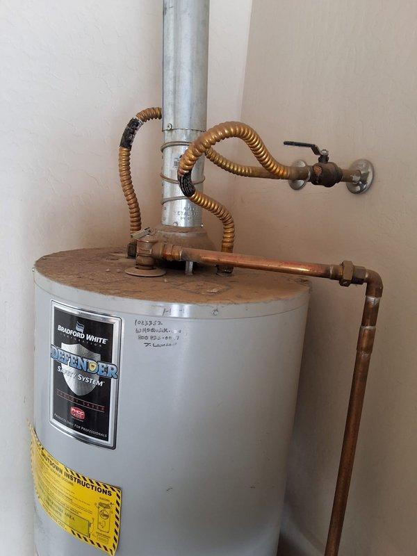 Completed full residential water heater replacement, removing and disposing of 16-year-old 50-gallon gas Bradford White unit. Installed new Bradford White 50-gallon gas water heater with direct vent system, including all necessary connections and safety components. Connected copper supply lines with flexible corrugated connectors, installed pressure relief valve assembly, verified proper venting through galvanized metal vent pipe, and positioned unit on white drain pan for code compliance. Tested all connections for leaks, verified proper gas combustion, confirmed temperature and pressure relief valve operation, and ensured all manufacturer specifications were met for safe operation.