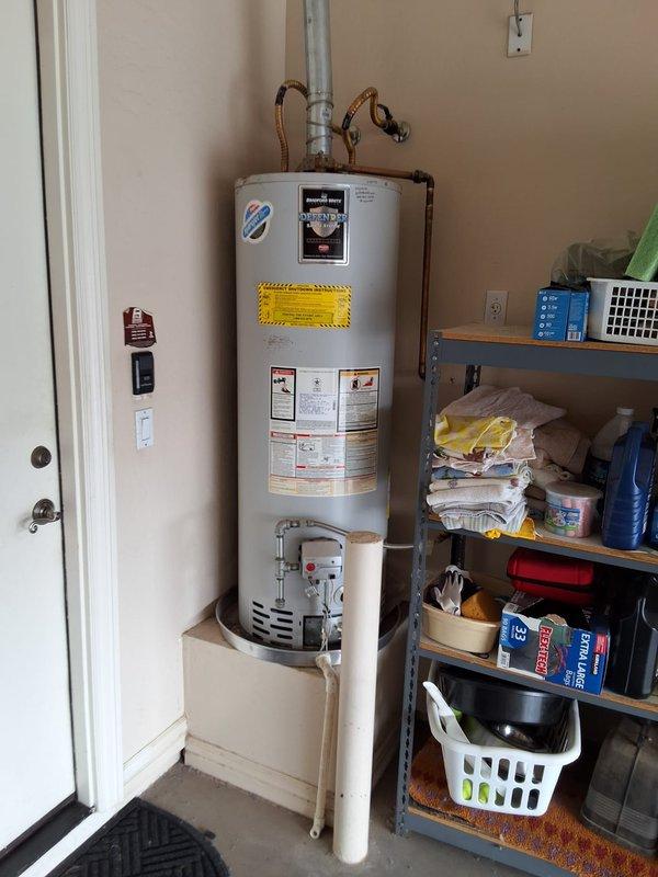 Completed full residential water heater replacement, removing and disposing of 16-year-old 50-gallon gas Bradford White unit. Installed new Bradford White 50-gallon gas water heater with direct vent system, including all necessary connections and safety components. Connected copper supply lines with flexible corrugated connectors, installed pressure relief valve assembly, verified proper venting through galvanized metal vent pipe, and positioned unit on white drain pan for code compliance. Tested all connections for leaks, verified proper gas combustion, confirmed temperature and pressure relief valve operation, and ensured all manufacturer specifications were met for safe operation.