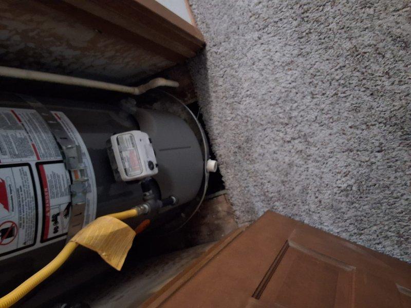Performed preventative maintenance inspection on 40-gallon gas water heater installed in residential utility closet. Assessed current unit condition, documented installation with photos showing horizontal tank configuration with yellow flex connector, and provided estimate for replacement with new 40-gallon gas water heater including permit requirements and available payment options.