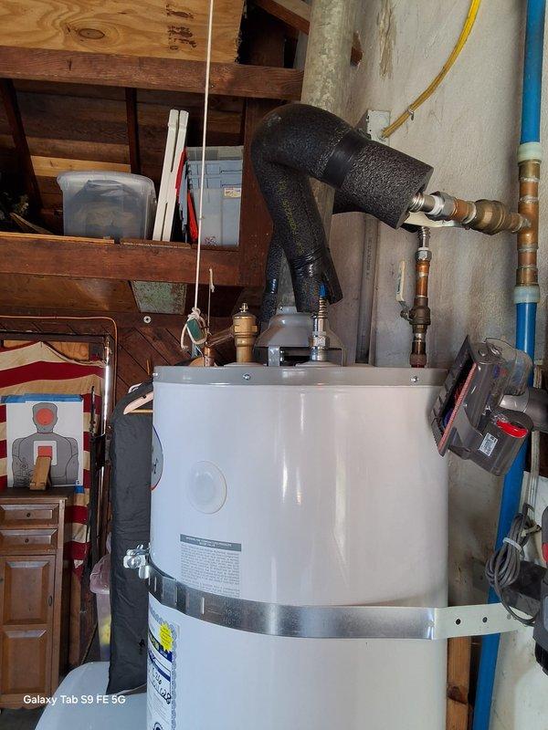 Responded to no hot water complaint on a 7+ year old gas water heater. Upon inspection, identified failed 40-gallon gas water heater (Model: SG40T12AVG00, Serial: 2009 GELN0210V06842) requiring complete replacement. Removed existing unit and installed new gas-fired water heater in basement utility area. Connected all water supply lines using copper piping, installed new gas line connections with flexible yellow gas supply, and properly vented unit with flue pipe assembly. Installed TPR valve with discharge piping per code requirements. Tested all connections for leaks, verified proper gas combustion, and confirmed hot water delivery throughout residence. Advised customer of permit requirements for installation and coordinated scheduling to expedite service completion.