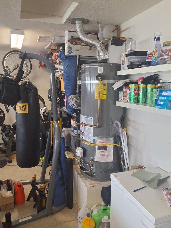 Replaced a 2019 Ruud 50-gallon residential gas water heater that had lost pilot function. Installed new unit in garage location with proper venting, gas flex connectors, and water line connections per manufacturer specifications. Discussed permit requirements and potential future modifications including tank relocation and gas line upgrades to meet current code requirements.