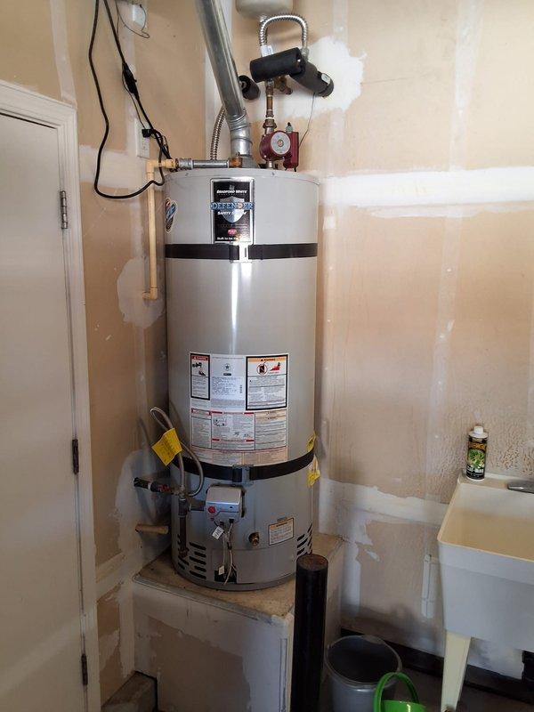 Performed inspection and estimate on an approximately 11-year-old Bradford White 50-gallon gas water heater. Unit evaluated for preventive replacement as requested. Assessed existing installation including gas line connections with flexible connector, copper supply piping with shutoff valves, pressure relief valve discharge piping, and recirculation pump system. Documented current equipment condition and configuration through photographs. Discussed replacement options with customer, who specifically requested another Bradford White unit. Noted permit requirements need to be addressed prior to replacement work. Follow-up appointment scheduled for future installation.