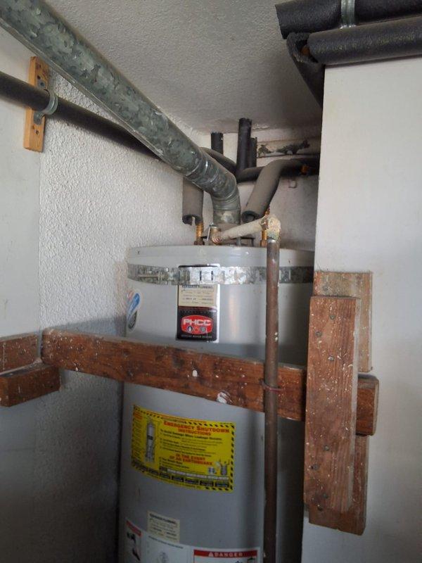 Responded to service call for leaking 50-gallon gas water heater located in garage. Removed and properly disposed of failed unit. Installed new GN50T1-3-6 gas water heater as replacement, ensuring all connections met current code requirements. Completed necessary modifications to bring installation into compliance with local building standards. Secured required permit for installation. Verified proper operation of new unit including gas connections, venting system, temperature and pressure relief valve, and all water supply lines. System tested and confirmed leak-free with no operational issues.