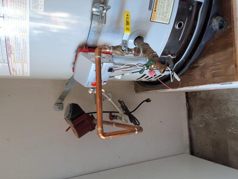 Completed full replacement of 75-gallon residential gas water heater in garage utility area. Removed existing unit and installed new 75-gallon gas water heater with all required connections including copper water supply lines, gas line connections, temperature and pressure relief valve, and proper venting system. Secured unit with metal strapping per code requirements, connected electrical components, and verified all plumbing connections for proper operation and leak-free performance.