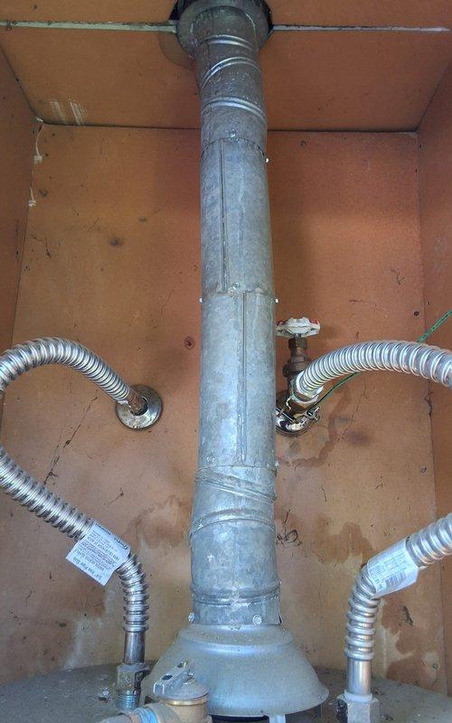 Completed full residential gas water heater replacement per approved estimate. Removed existing 40-gallon gas water heater (Model U440T6FRN, Serial KH18713983) from outdoor closet location and installed new 40-gallon gas water heater (Model GN40T1-3-6) with drain pan. Connected gas supply lines using flexible metallic connectors with shutoff valves on both sides, installed new galvanized metal flue vent pipe with proper vertical routing through enclosure ceiling, and verified all connections for proper operation and safety. Customer approved permit requirements prior to installation. All work completed to code specifications with system tested and operational upon departure.