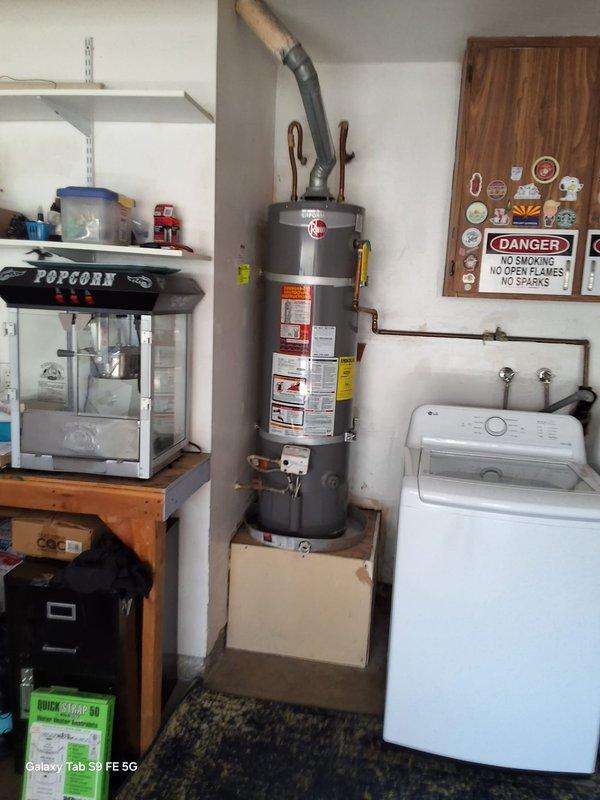 Responded to a leaking 11-year-old 29-gallon gas water heater (model XG29T09FG3) and successfully replaced it with a new 40-gallon gas water heater unit. Removed the failed tank, installed the replacement unit with proper venting and gas connections, and positioned it on a drain pan in the utility room. All safety labels, warning placards, and plumbing connections were properly installed and tested for proper operation.
