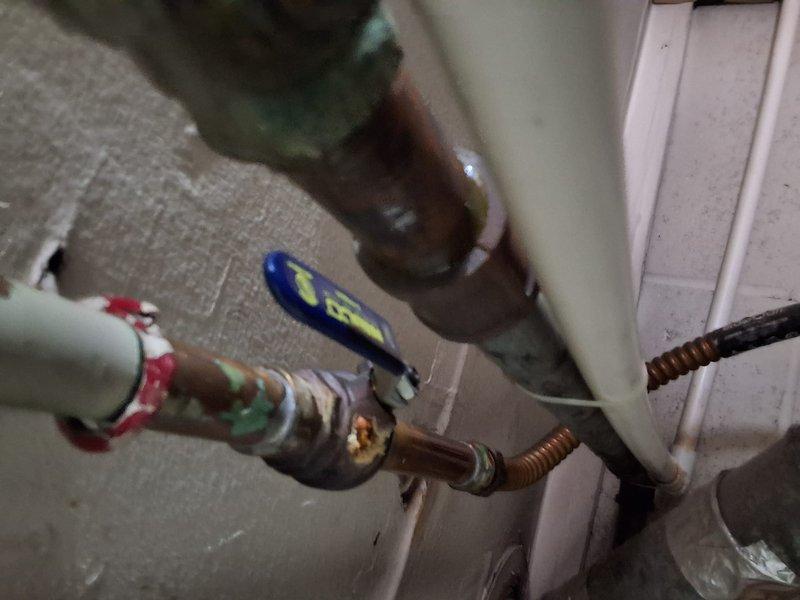 Responded to service call for leaking gas water heater. Inspected existing 40 or 50 gallon gas unit and confirmed active gas leak requiring replacement. Unit age and model information unavailable due to worn or missing data plate. Documented existing installation with photos showing current plumbing connections, gas line configuration, and mounting hardware. Provided estimate for replacement with new 50 gallon gas water heater. Discussed permit requirements for installation and available payment methods. No equipment model number or specific pricing ballpark provided at time of inspection.
