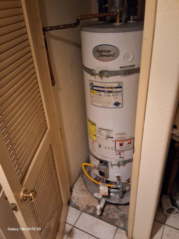 Responded to no pilot light condition on American Standard natural gas water heater model GN50T1-3-6NAT. Upon arrival, inspected gas control valve, thermocouple, and pilot assembly. Verified gas supply through yellow flexible connector and confirmed proper venting. Successfully relit pilot light and tested main burner operation to ensure proper ignition sequence and flame characteristics. Unit restored to full operational status under manufacturer warranty coverage.