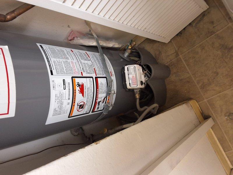 Responded to property management call for no hot water condition at residential unit. Performed onsite evaluation of existing residential water heater installation. Unit inspected for operational status, visible leaks, proper venting, and plumbing connections. Documented current equipment condition with photographs showing gray cylindrical water heater with standard piping, pressure relief valve, control components, and proper ventilation in utility closet setting. Findings reported to office for pricing determination on necessary repairs or replacement per property management protocol.