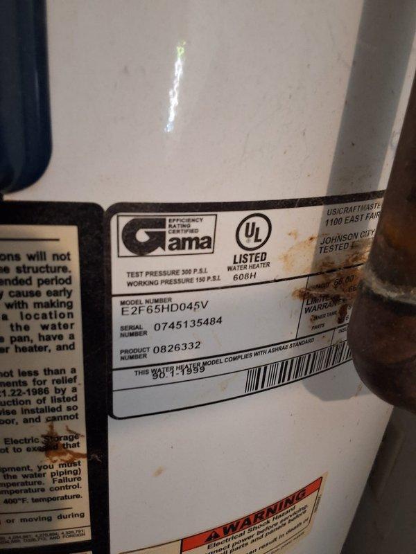Performed inspection on leaking Whirlpool water heater (Model: E2F65HD0452, Serial: 0826332) located in utility room. Documented unit condition with photographs showing visible wear on exterior casing, existing plumbing connections including copper supply lines, PVC discharge piping, and flexible connector at top of unit. Discussed permit requirements with property owner and explained available payment options for future replacement or repair work.