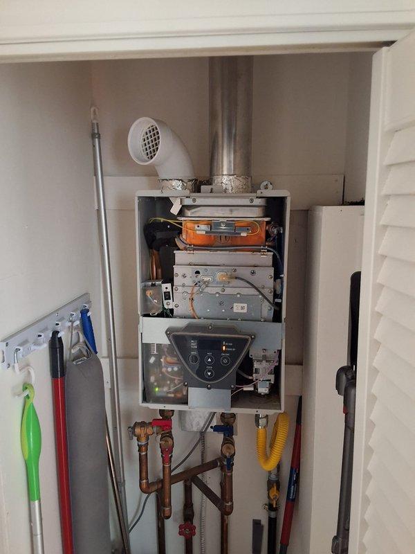 Responded to service call for Takagi tankless water heater experiencing ignition issues. Performed diagnostic inspection of unit with front cover removed to access internal components including heat exchanger, burner assembly, control panel, and electrical connections. Evaluated condition of copper piping, gas supply line, shut-off valves, and venting system. Discussed replacement options with Navien tankless water heater as alternative solution. Provided estimate for repair service and full system replacement with permit requirements. Documented equipment condition through photographs and presented available payment methods for approved work.
