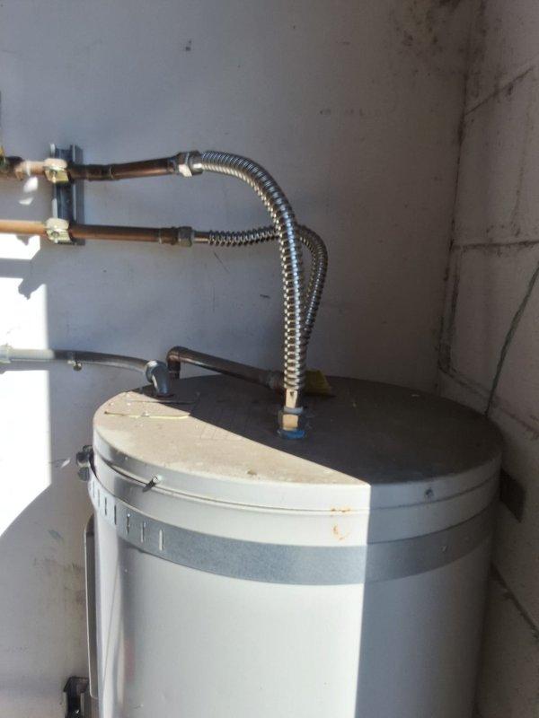 Responded to a leaking 13-year-old 40-gallon electric lowboy water heater (Model: M240S6DS, Serial: KH18788413) located in a warehouse commercial building serving only kitchen and bathroom facilities. Successfully removed and replaced the failed unit with a new 40-gallon electric lowboy tank. Completed all necessary water and electrical connections using flexible metal conduit and copper piping, ensuring proper installation and system functionality upon completion.