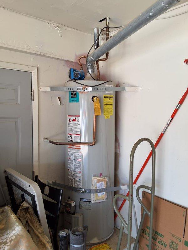Performed inspection and estimate on existing 40-gallon gas water heater located in garage. Unit shows age-related wear and homeowner requested preventative replacement. Provided quote for new 40-gallon gas water heater model GN40T1-3-6 with 12-year warranty, discussed permit requirements and code compliance modifications needed for installation. Documented existing equipment condition with photographs showing current installation, piping configuration, and venting system. Scheduled follow-up appointment for installation pending approval.
