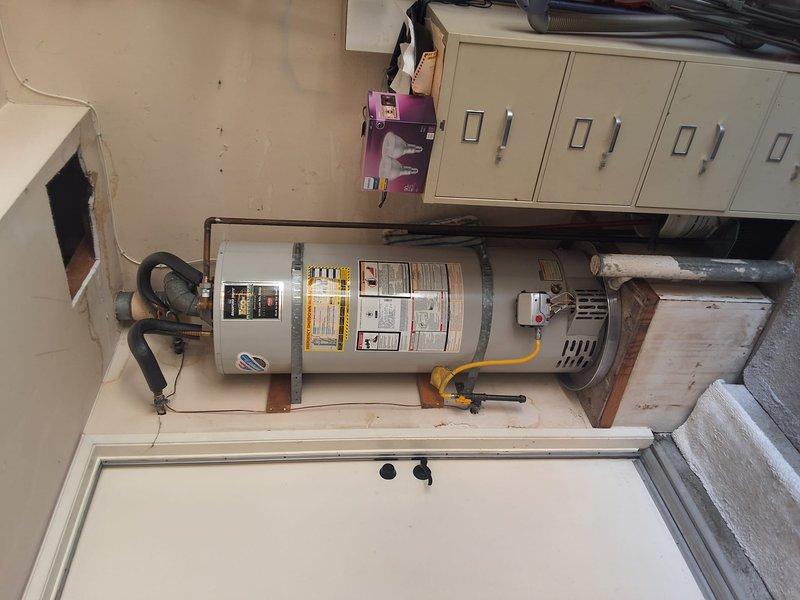 Replaced aging 50-gallon residential gas water heater with new unit in utility closet. Disconnected and removed old water heater, installed replacement 50-gallon gas water heater with proper venting, connected water supply lines using black flexible connectors, and reconnected gas line. Verified all connections for leaks, tested unit operation, and ensured compliance with local building codes and permit requirements.