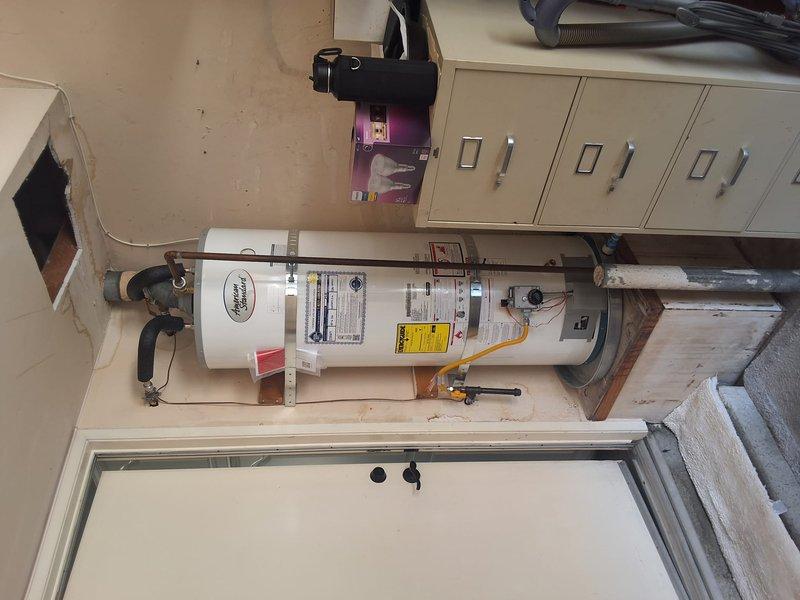 Replaced aging 50-gallon residential gas water heater with new unit in utility closet. Disconnected and removed old water heater, installed replacement 50-gallon gas water heater with proper venting, connected water supply lines using black flexible connectors, and reconnected gas line. Verified all connections for leaks, tested unit operation, and ensured compliance with local building codes and permit requirements.
