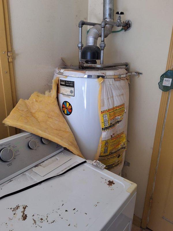 Removed and replaced aging Montgomery Ward "Three Hundred" gas water heater showing significant rust staining and exterior deterioration. Installed new gas water heater with proper connections to existing gas line and plumbing, ensuring all safety codes and manufacturer specifications were met. Discussed permit requirements and payment options with property owner upon completion of installation.