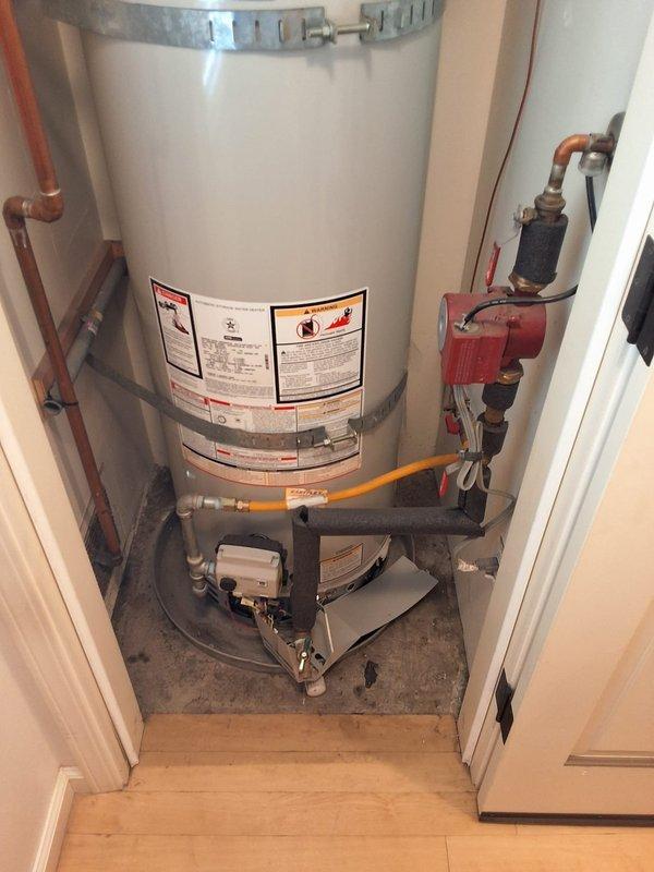 Performed inspection and provided replacement estimate for 9-year-old 50-gallon gas water heater, model URG250H6N, serial number NM38758102, originally installed by our company. Discussed permit requirements and presented two replacement options: upgrading to the same URG250H6N model or installing a standard 50-gallon gas unit. Documented existing installation with photographs showing current plumbing connections, gas line, pressure relief valve, and overall unit condition in utility closet location.