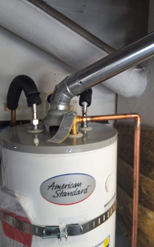 Responded to no hot water warranty call on American Standard water heater model GN40T1-3-6, serial C26-008640, within first year of installation. Performed diagnostic inspection of unit and all plumbing connections including gas valve, copper supply lines, and flexible hose connections at top of tank. Verified proper operation of water heater, confirmed all connections secure, and resolved issue under warranty coverage with no charge to customer.
