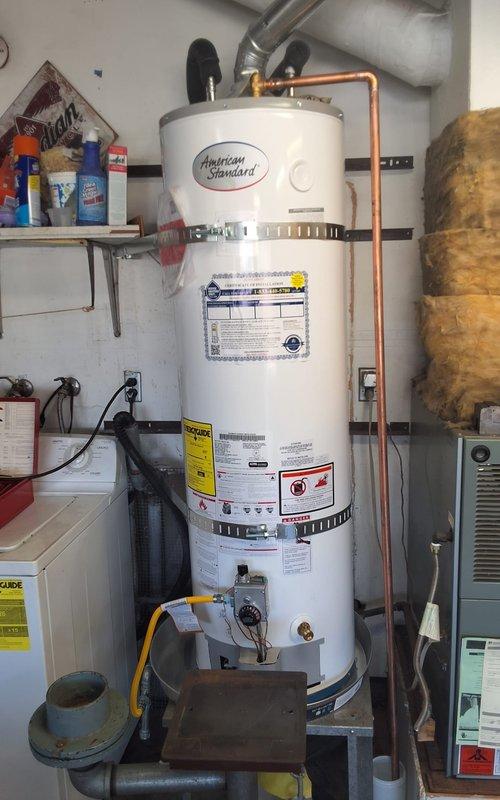 Responded to no hot water warranty call on American Standard water heater model GN40T1-3-6, serial C26-008640, within first year of installation. Performed diagnostic inspection of unit and all plumbing connections including gas valve, copper supply lines, and flexible hose connections at top of tank. Verified proper operation of water heater, confirmed all connections secure, and resolved issue under warranty coverage with no charge to customer.