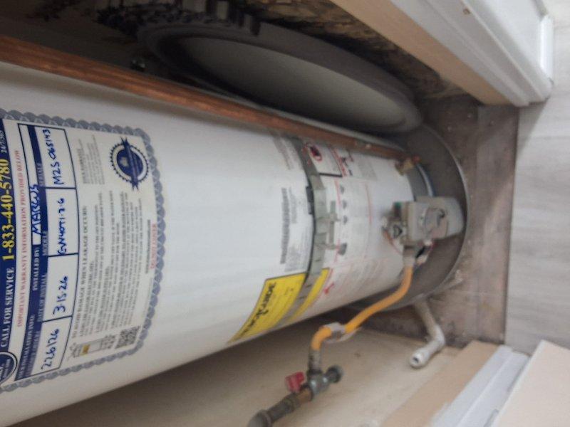 Performed warranty service on Goodman water heater model GN40T1-3-6, serial number M25-065143. Inspected unit installation, verified proper plumbing connections including copper piping and flexible connectors, and confirmed drip pan placement. Evaluated insulated pipe runs and ensured all components were functioning correctly under first-year warranty coverage.