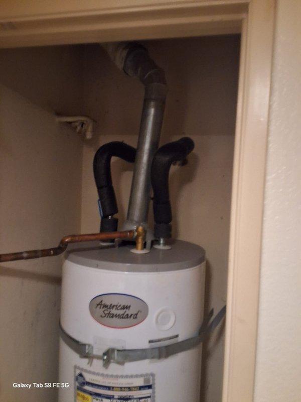 Responded to no hot water complaint on American Standard natural gas water heater model GN50T1-3-6NAT. Performed manufacturer warranty service including thorough cleaning of burner assembly and pilot assembly, and removed insulation material from bottom of unit that was potentially interfering with proper combustion. Unit restored to proper operation with hot water production confirmed upon completion.