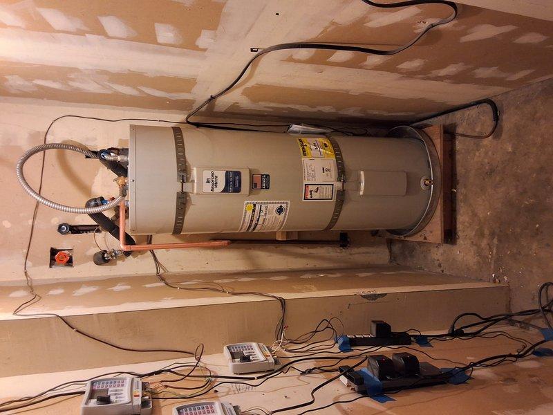 Completed full residential water heater replacement at rental property as preventative measure in advance of heat pump mandate regulations. Removed existing Bradford White URG140 40-gallon gas water heater (S#WE45140214) and installed new American Standard 40-gallon gas water heater. Installation included proper mounting with seismic strapping brackets for code compliance, connection of gas supply line via black pipe, copper water supply piping connections, temperature and pressure relief valve installation with discharge piping, and electrical connections. Unit secured to wooden platform base on concrete floor in basement utility area. All connections tested and verified for proper operation and safety. Municipal permit obtained and work performed to current building code standards.