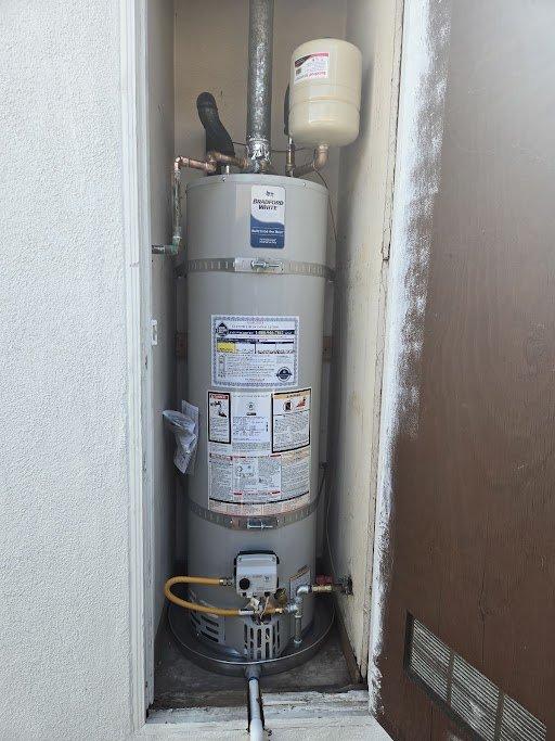 Responded to warranty service call for Bradford White gas water heater model URG140T6N. Upon inspection, found that the flexible gas line installation was improperly positioned, blocking access to the drain valve and preventing routine flushing maintenance. Relocated and reinstalled gas line to proper position, ensuring clearance from drain valve while maintaining code-compliant connections and safe operation. Verified all gas connections for leaks, confirmed proper water heater function, and restored full access to drain valve for future maintenance requirements.