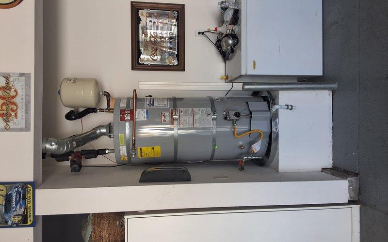 Replaced a failed 21-year-old A.O. Smith 75-gallon residential water heater (Model FCG75270, Serial M04J068394) that was actively leaking. Installed new water heater with proper connections including gas line, water supply lines, expansion tank, venting, and safety devices per manufacturer specifications and local code requirements. Permit requirements were discussed with property owner prior to scheduling installation.