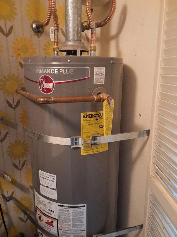 Replaced leaking 40-gallon gas water heater, over 10 years old, located in laundry room. Installed new Rheem Performance Plus model GN40T1-3-6 with 12-year warranty, including proper copper piping connections, flexible gas line installation, and seismic strapping per code requirements. Permitting was discussed and offered to customer for compliance with local building regulations.