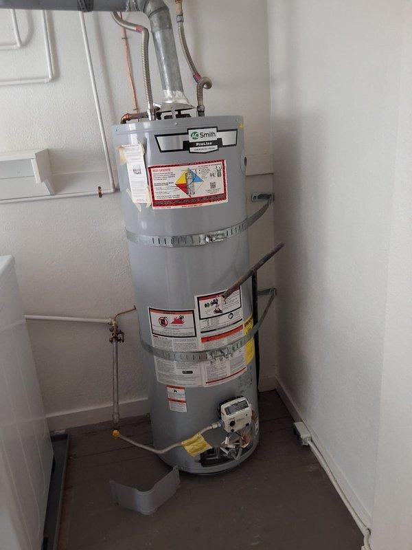 Replaced out-of-warranty 40-gallon gas water heater with new A.O. Smith model GN40T1-3-6. Removed existing unit, installed replacement water heater with proper venting, gas connections, and water supply lines, secured unit with seismic straps, and installed drain pan for leak protection.