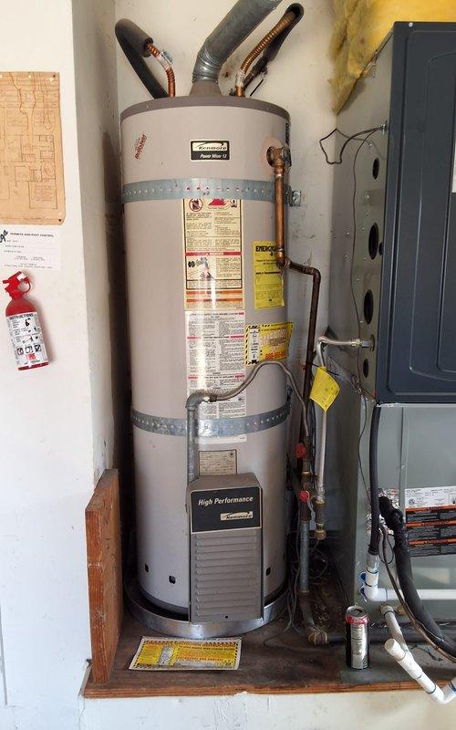 Replaced 20+ year old Kenmore 50-gallon gas water heater (Model #153.330.552) with new American Standard 50-gallon gas water heater. Installed unit with proper copper piping connections, gas line hookup, and venting system. Secured all plumbing connections with appropriate shut-off valves and obtained required municipal permit for installation.
